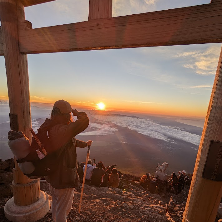 Yanis watching the sunrise from the summit of Mount Fuji